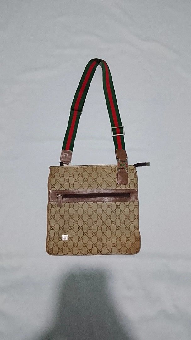 Gucci Monogram Canvas Crossbody Bag with Web Strap (Category: Luxury Bags & Wallets) located in Cagayan de Oro. Submitted by friderickv99131 (Listing ID 1469718723, Image 1). Description: - 100% Authentic Gucci Messenger Bag - Classic beige GG monogram canvas with durable brown leather trim - Signature green and red web strap with adjustable buckle - Secure top zip closure and convenient front zip pocket - Flat, rectangular everyday design that f