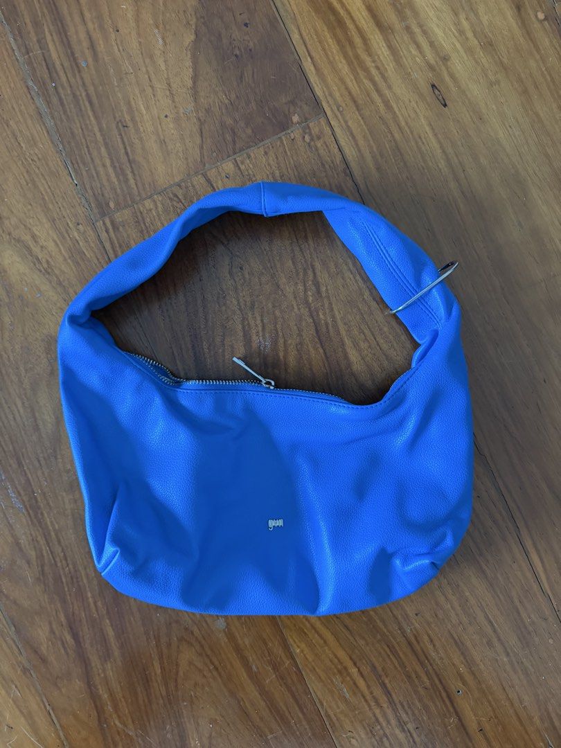 GVN Blue Small Hobo Bag in Azure (Category: Shoulder Bags) located in Pasig City. Submitted by yoloswaggin_ (Listing ID 1469620939, Image 1). Description: - Color: Vibrant blue - Material: Textured faux leather - Style: Slouchy hobo shoulder bag - Closure: Top zipper with silver metal pull - Details: Small silver front logo and built-in strap ring - Interior: Clean lined interior - discontinued style.