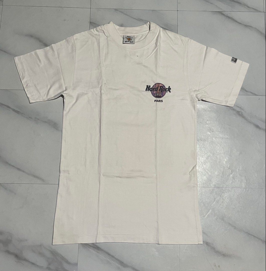 HARD TAG Hard Rock Cafe Paris Heavy Tee White Small (Category: Tshirts & Polo Shirts ) located in Cavite. Submitted by christianzuuu (Listing ID 1469603280, Image 1). Description: - Authentic Hard Rock Cafe Paris T-Shirt - Color: White - Size: Small (fits true to size) - Measurements: 17.5" pit to pit, 28.5" length - Material: Premium heavyweight cotton - Design details: Front chest logo, large Eiffel Tower back graphic, and 'HRC Built on Rock n 