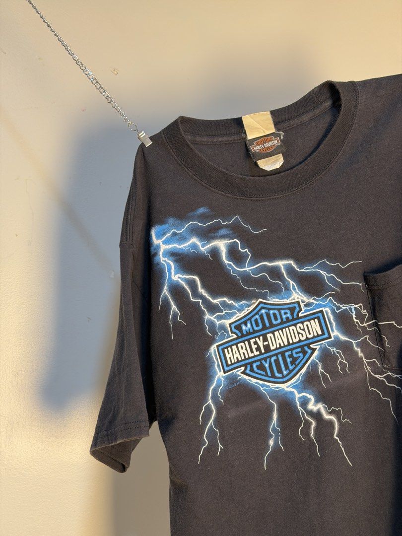Harley Davidson Lighting Storm⚡️🇨🇳 (Category: Tshirts & Polo Shirts ) located in Manila. Submitted by sugbo_vntg (Listing ID 1469746126, Image 2). Description: Harley-Davidson “Lightning Storm” ⚡🇨🇳 A Harley Davidson logo with electric blue lightning striking across the chest and a golden eagle rises out of a ring of fire above Harley-Davidson of Shanghai China. Size: M | 20 x 28 Available🔥.
