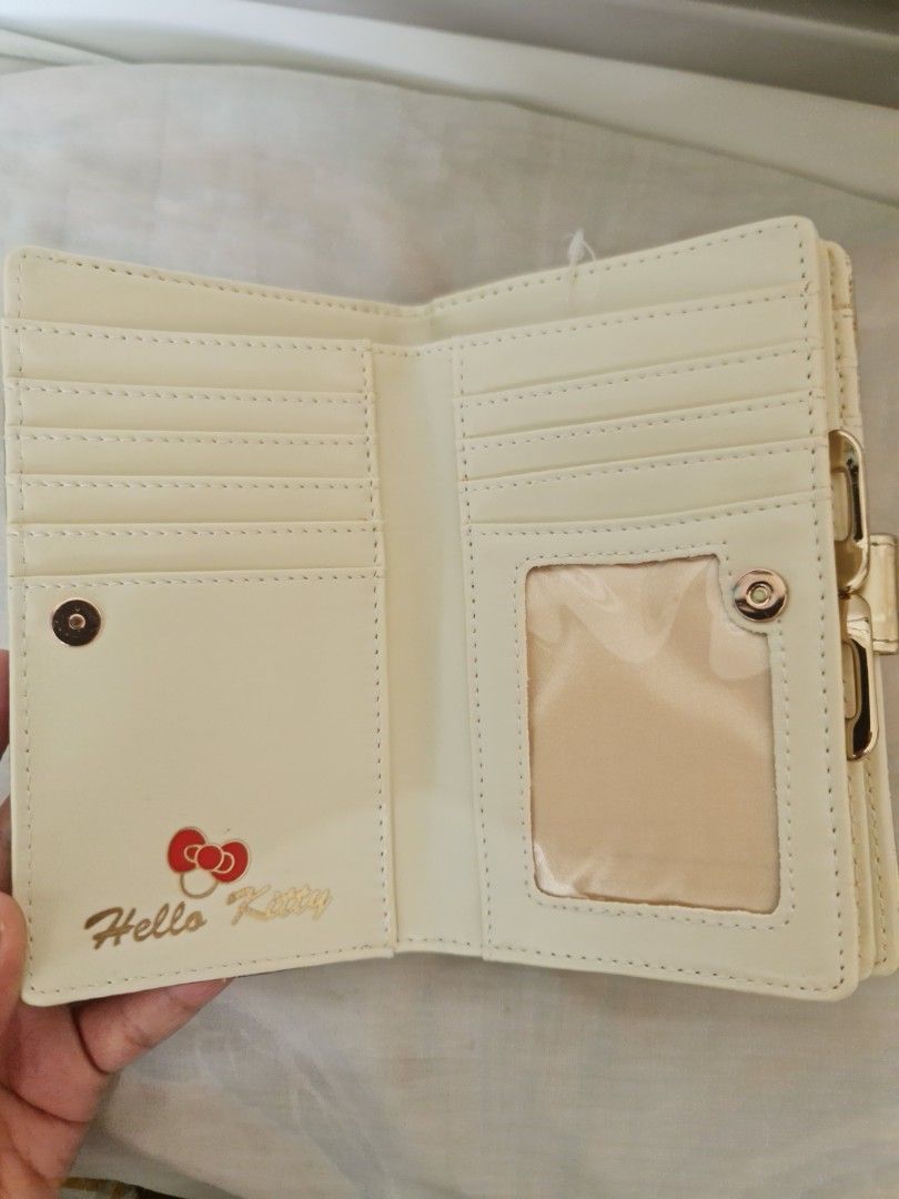Hello Kitty Gold Quilted Wallet Purse (Category: Wallets & Card holders) located in Marilao. Submitted by joycehart (Listing ID 1469611904, Image 3). Description: - Elegant gold quilted design featuring a sparkly Kitty heart charm and back bow detail - Secure snap button closure and kiss-lock zippered coin compartment - Organized interior with multiple card slots and a clear ID window - Beautiful cream-colored lining complete with an official Kit