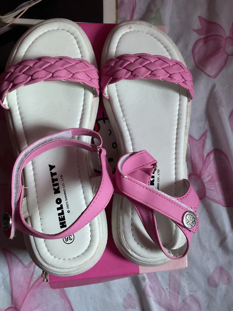 Hello Kitty Pink Platform Sandals Size 36 (Category: Flats & Sandals) located in San Juan City. Submitted by bookmarket_manila (Listing ID 1469651698, Image 1). Description: - Authentic Sanrio Kitty platform sandals - Color: Pink and white - Size: 36 - Braided strap detail and secure ankle strap with hook-and-loop closure - Cute silver Kitty charm on the side - Printed Kitty branding on the footbed - Includes original pink Sanrio shoebox from SM 
