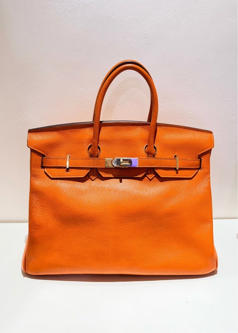 Hermes Birkin Orange Leather Bag (Category: Luxury Bags & Wallets) located in Manila. Submitted by chellorix133878 (Listing ID 1469684638, Image 1). Description: - Japan Surplus Source Hermes Birkin tote size 40 in a striking bright orange grained leather - Features secure palladium hardware closure straps across the front - Classic structured shape with neat, clean stitching throughout - Double rolled top handles for comfortable hand or arm carr