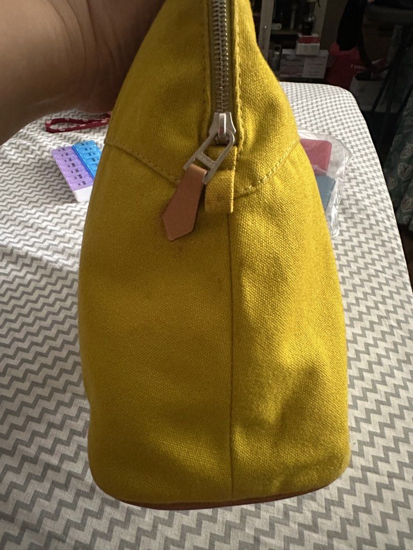 Hermès Yellow Canvas Pouch (Category: Purses & Pouches) located in Antipolo. Submitted by prelovedcloseta (Listing ID 1469609607, Image 3). Description: - Color: Bright yellow canvas with brown leather base trim - Design: Embroidered H logo inside an oval on the front - Closure: Zipper closure with a convenient leather pull tab - Interior: Clean fabric inside and out, structured shape to keep items organized - Condition: Excellent, well-maintaine