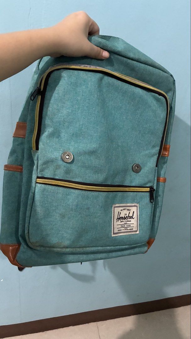 Herschel Supply Co. Teal Canvas Backpack (Category: Backpacks) located in Manila. Submitted by dukejah (Listing ID 1469579997, Image 3). Description: - Color: Teal canvas with brown faux leather trim - Storage: Main zip compartment with internal laptop sleeve and securing strap - Pockets: Front zip pocket for small items and magnetic snap flap closure - Comfort: Padded, fully adjustable mesh shoulder straps - Condition: Clean interior lining, wit
