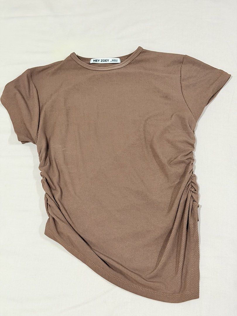 Hey Zoey Brown Ribbed Top Size 2 large (Category: Sleeveless) located in Paranaque City. Submitted by hannahking36 (Listing ID 1469585535, Image 1). Description: - Brand: Hey Zoey - Size: 2 - Color: Brown - Material: Stretchy ribbed knit fabric for a super comfortable fit - Design: Crew neck and short sleeves - Detail: Asymmetrical side ruching with a chic draped hemline.