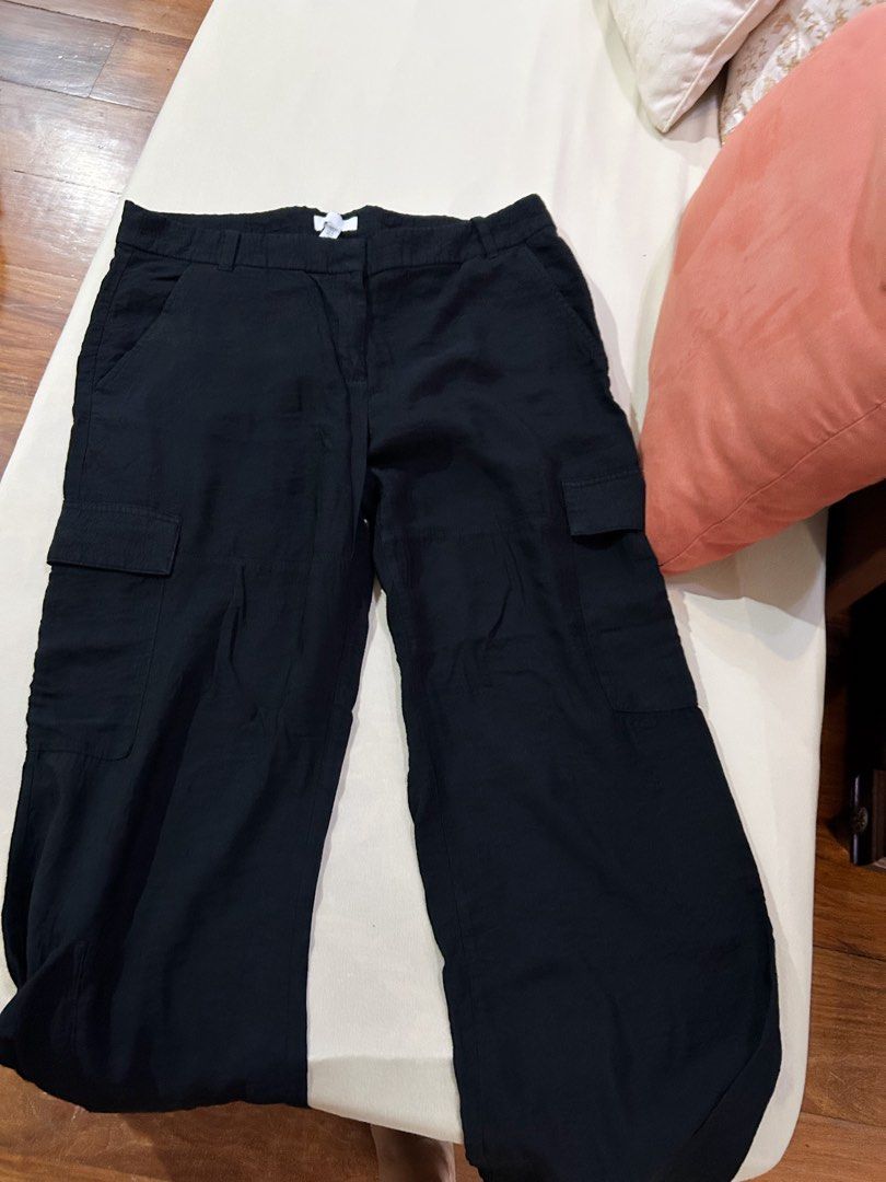 H&M Black Satin Cargo Pants/ Trousers (Category: Jeans) located in Cainta. Submitted by unboxingstuff (Listing ID 1469651387, Image 3). Description: - Style: SATIN material - Size: EUR 46/ US 14 - Casual everyday black cargo pants with a straight-leg cut - Can be used as business casual wear too - Pockets: Functional utility pockets on both sides - Waist: High waist with button and hook closure, plus belt loops - Material: Lightweight, comfortabl