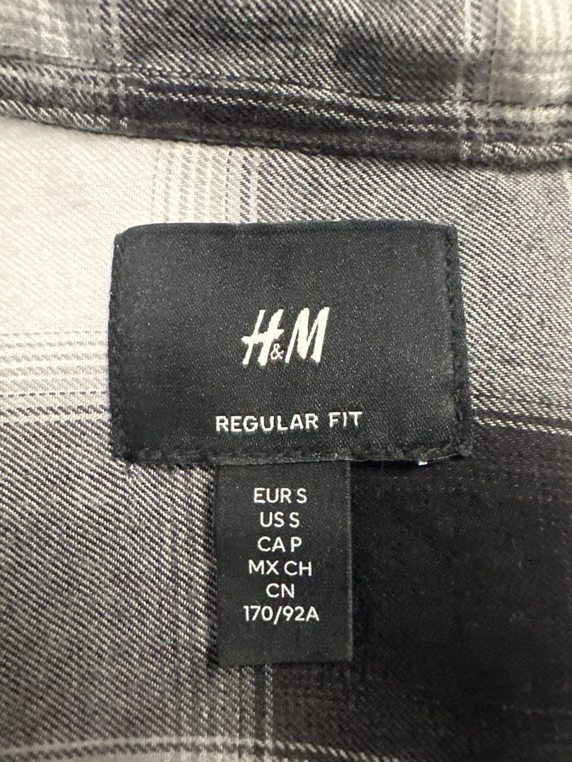 H&M Black White Checkered Regular Fit Shirt (Category: Tshirts & Polo Shirts ) located in Manila. Submitted by lameloball18 (Listing ID 1469717304, Image 2). Description: - Brand: H&M - Size: Small - Color/Pattern: Black and white plaid / checked - Fit: Regular fit with standard collar and long sleeves - Closure: Front button-down - Styling: Easy to pair with jeans or layer over t-shirts - Condition: Excellent, well-maintained.