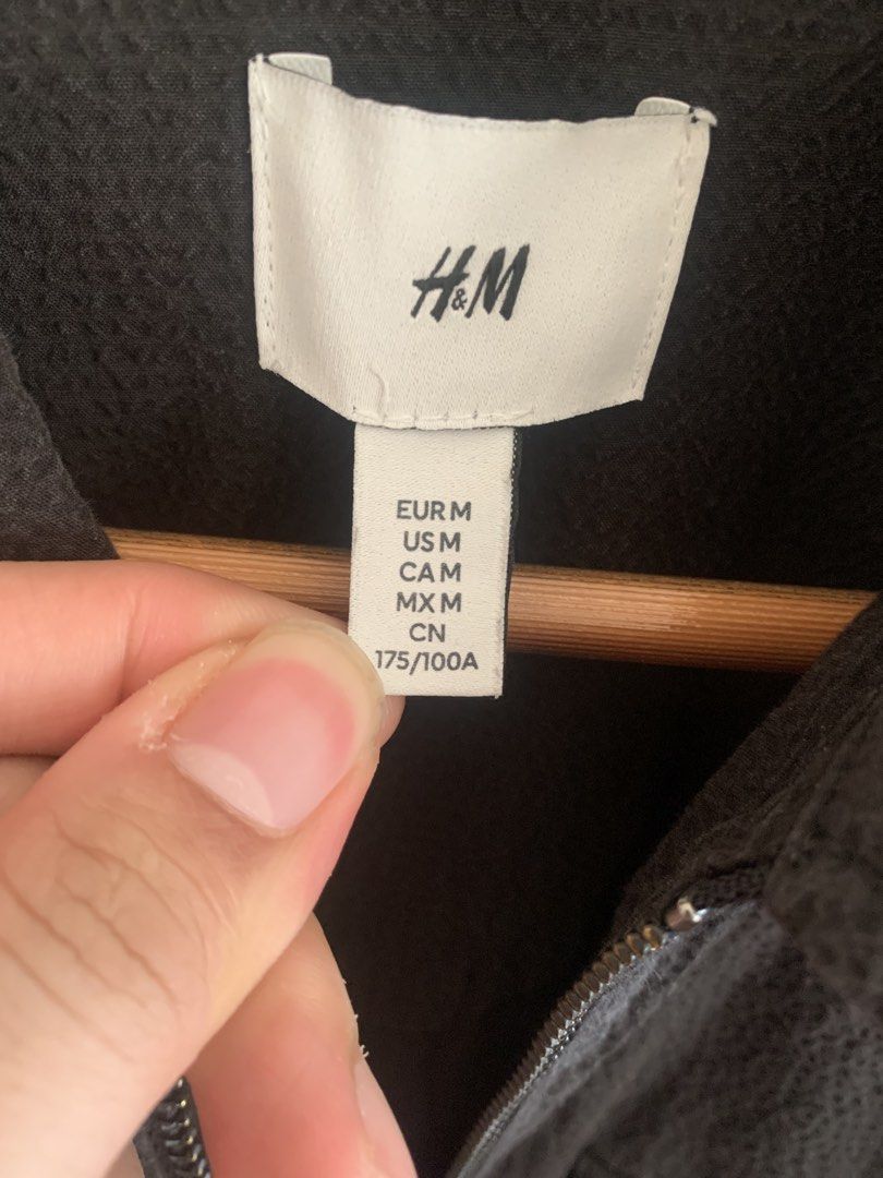 H&M Black Zip-Up Jacket (Category: Coats, Jackets and Outerwear) located in Pasig City. Submitted by krram_consta (Listing ID 1469626758, Image 2). Description: - Brand: H&M - Color: Black - Size: Medium (Can Fit Large) - Full-zip with standard collar - Two chest flap pockets - Long sleeves with button cuffs - Textured fabric throughout.