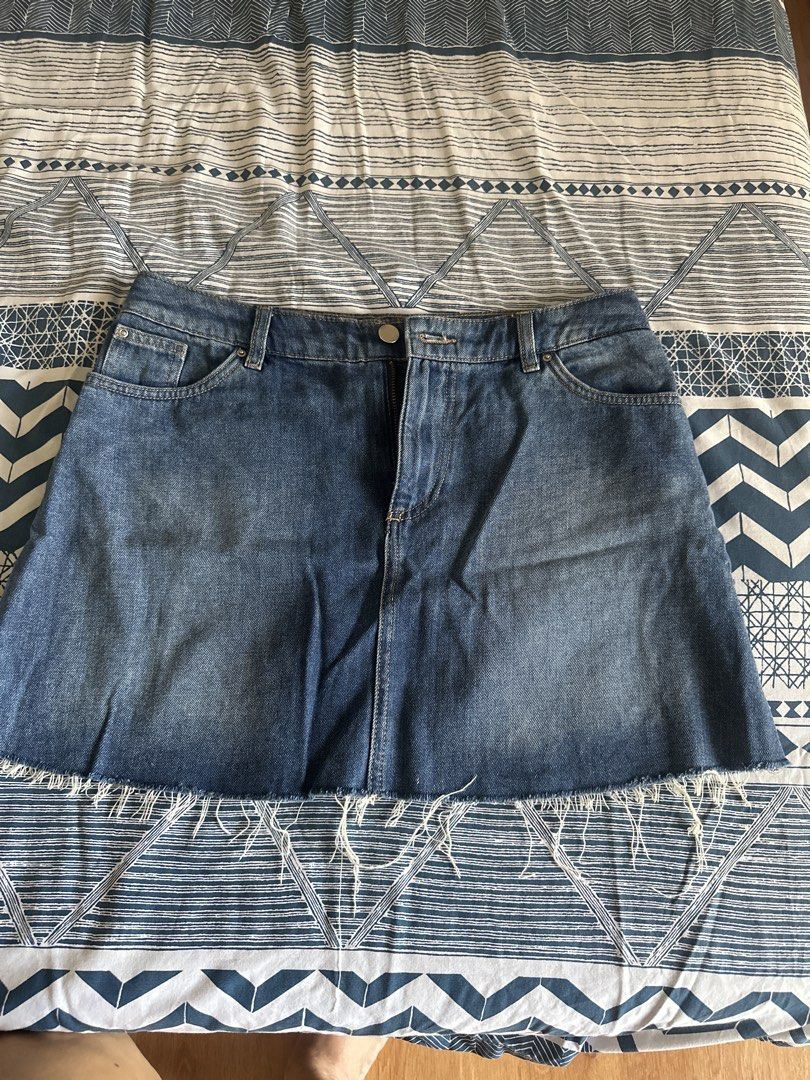 H&M Divided Denim Skirt Size US 8 (Category: Skirts) located in Manila. Submitted by amazingamie8 (Listing ID 1469581405, Image 1). Description: - Brand: H&M Divided - Style: Denim skirt with raw frayed hem - Wash: Medium blue - Size: EUR 38 / US 8 / CN 165/72A - Details: Classic five-pocket styling, zip fly, and button closure - Condition: Good staple piece for casual everyday outfits.