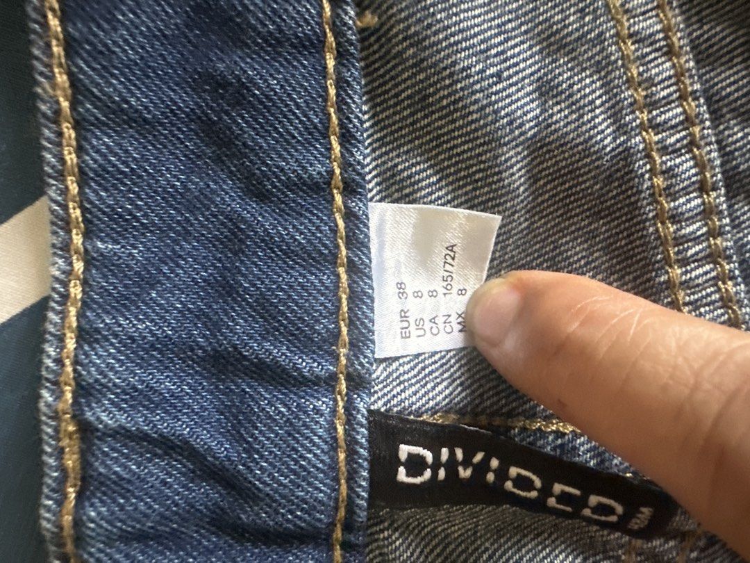H&M Divided Denim Skirt Size US 8 (Category: Skirts) located in Manila. Submitted by amazingamie8 (Listing ID 1469581405, Image 3). Description: - Brand: H&M Divided - Style: Denim skirt with raw frayed hem - Wash: Medium blue - Size: EUR 38 / US 8 / CN 165/72A - Details: Classic five-pocket styling, zip fly, and button closure - Condition: Good staple piece for casual everyday outfits.