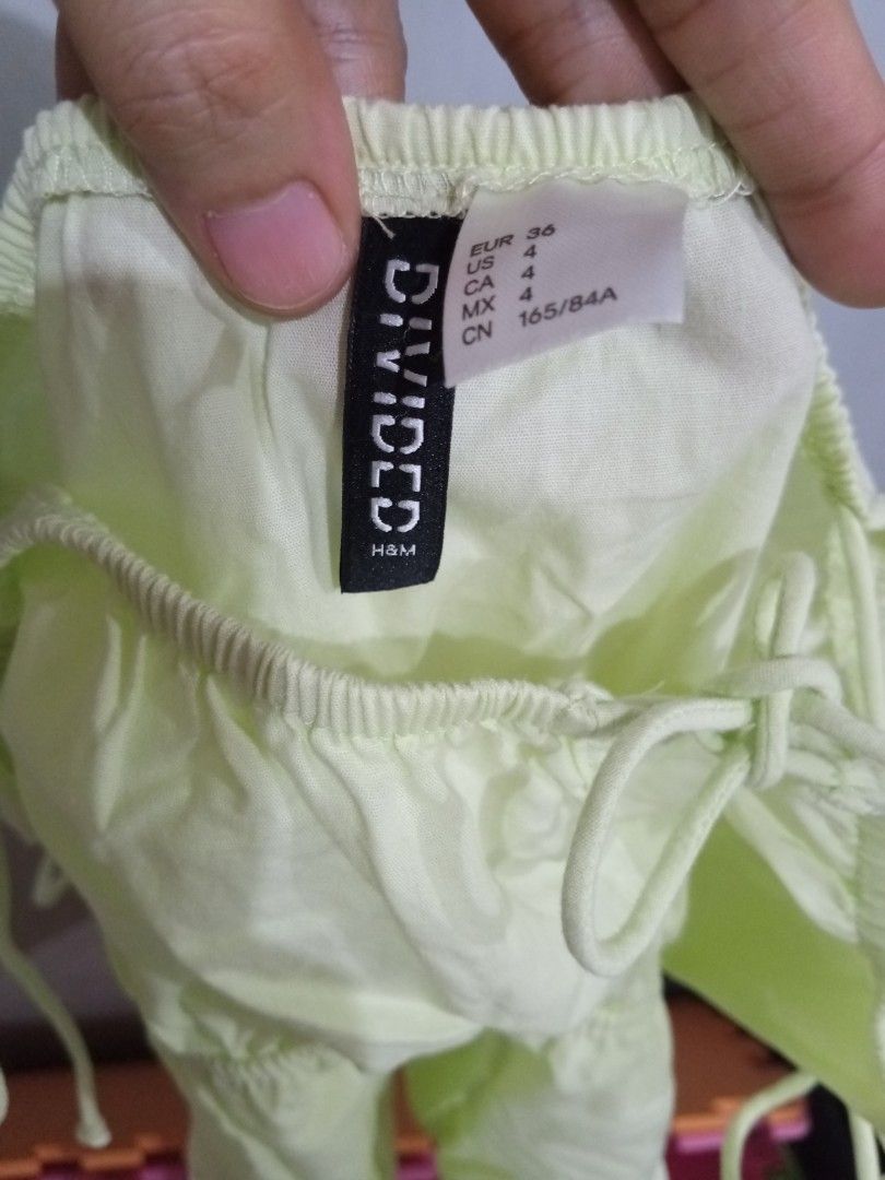 H&M Divided Lime Green Tiered Cami Top (Category: Sleeveless) located in Bacoor. Submitted by thriftworksph (Listing ID 1469602744, Image 3). Description: - Brand: H&M Divided - Color: Lime Green - Size: EUR 36 / US 4 / CN 165/84A - Design: Square neckline, tie shoulder straps, front tie closure - Details: Smocked bodice with a tiered flowy hem - Material: Lightweight, ideal for warm weather.