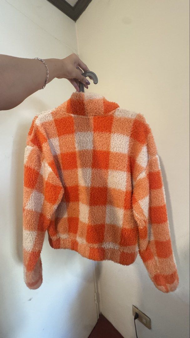 H&M Divided Orange Checkered Sherpa Fleece Jacket (Category: Coats, Jackets and Outerwear) located in Makati City. Submitted by marykay05 (Listing ID 1469619646, Image 3). Description: - Brand: H&M Divided - Size: XS - Design: Orange and white checkered pattern - Style: Quarter zip, high neck, cropped length, relaxed fit - Material: Super soft fuzzy fleece - Perfect for: Cold weather streetwear.