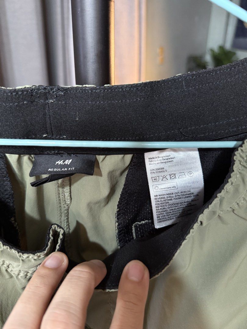 H&M Regular Fit Green Cargo Pants (Category: Joggers) located in Manila. Submitted by gochaseme (Listing ID 1469663096, Image 2). Description: - Brand: H&M - Item: Regular Fit Cargo Pants - Color: Light Green - Material: 87% polyamide, 13% elastane (lightweight & stretchy) - Features: Elastic waistband with adjustable drawstring, multiple utility pockets, and "COMPACT suited for all conditions and environments" print - Ideal for: Outdoor activiti