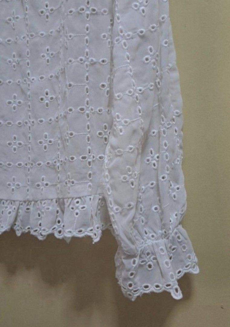 H&M White Dainty Eyelet Blouse (Category: Blouses) located in Manila. Submitted by thrifter_lifestyle (Listing ID 1469581385, Image 3). Description: Brand: H&M Long sleeves, garterized on wrists Single button enclosure at the back Round neck with lace Material: Polyester, textured fabric Fabric has eyelets all over, so best worn with inner. Added close up photos for appreciation. 🙂 Actual Color: Off White/Light Ecru Bust: 42" Length (shoulder to