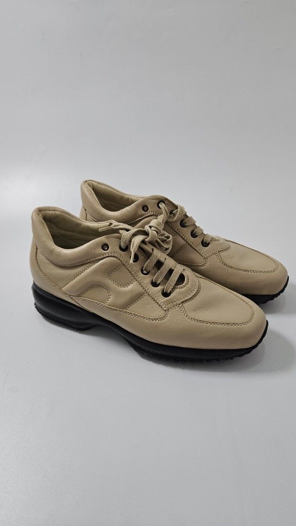 Hogan Interactive Beige Leather Sneakers (Category: Sneakers) located in Alfonso. Submitted by jbcamet (Listing ID 1469702815, Image 1). Description: - Brand: Hogan Interactive - Material: Premium beige leather - Design: Classic lace-up front with signature H side logo - Sole: Chunky black rubber sole for added comfort and height - Authenticity: Interior tag and stamped insoles visible - Style: Versatile neutral colorway that pairs easily with ev