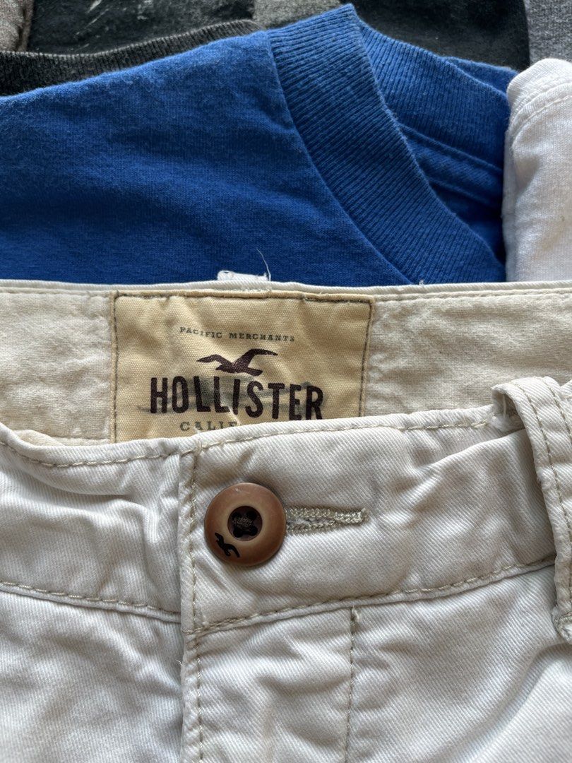 Hollister White Chino Shorts (Category: Shorts) located in Baao. Submitted by plainclothesdept (Listing ID 1469696902, Image 3). Description: hollister white relaxed shorts waist - 28 in. length - 17 in. hem - 10 in. discoloration - Brand: Hollister - Item: Men's Chino Shorts - Color: White - Closure: Classic button fly with branded buttons - Pockets: Front slash pockets and rear welt pockets - Details: Embroidered gull logo on the back pocket - 