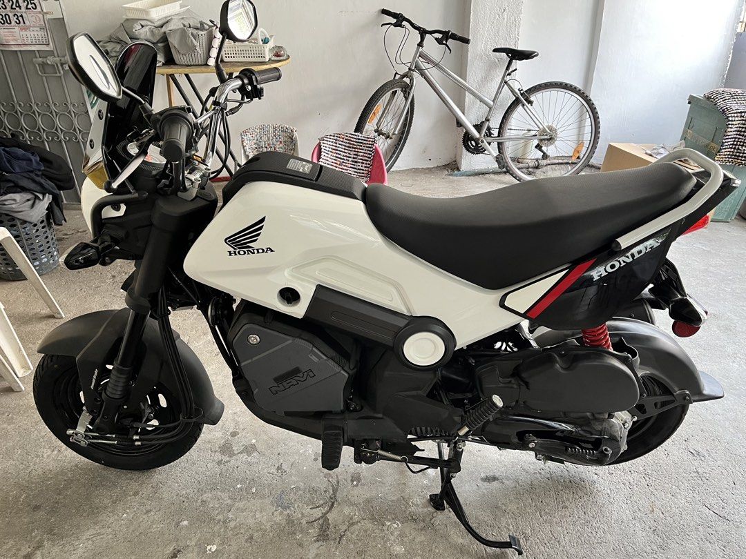Honda Navi White Scooter Motorcycle (Category: Motorbikes for Sale) located in Cainta. Submitted by joserzsants (Listing ID 1469651948, Image 2). Description: White Honda Navi scooter up for grabs. Clean body panels, black wheels, red rear shock. Stock exhaust pipe installed. Small utility box area near the engine block. Comfortable black rider seat. Handlebars equipped with mirrors and windshield. Starts and runs well. Great daily commuter aroun