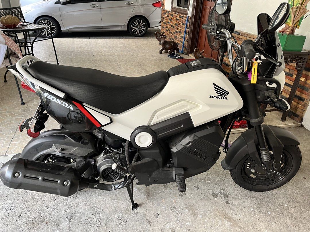 Honda Navi White Scooter Motorcycle (Category: Motorbikes for Sale) located in Cainta. Submitted by joserzsants (Listing ID 1469651948, Image 1). Description: White Honda Navi scooter up for grabs. Clean body panels, black wheels, red rear shock. Stock exhaust pipe installed. Small utility box area near the engine block. Comfortable black rider seat. Handlebars equipped with mirrors and windshield. Starts and runs well. Great daily commuter aroun
