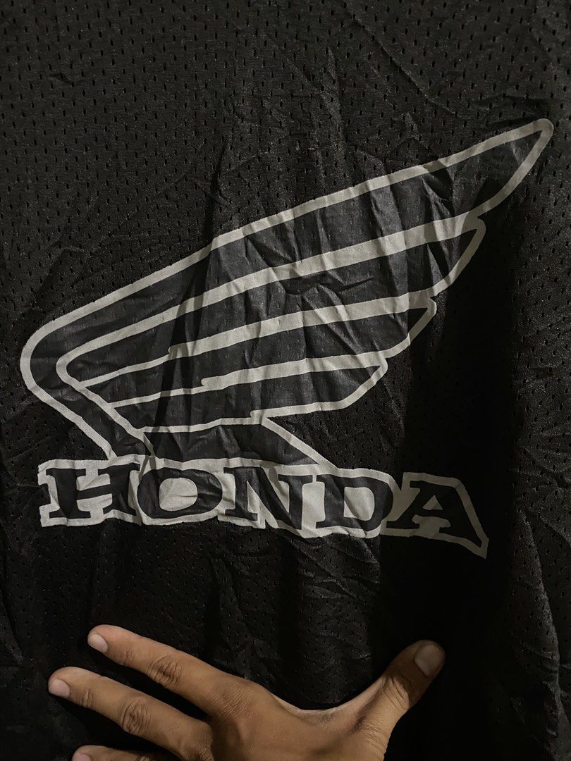 Honda Phys Dept Black Mesh Jersey (Category: Activewear) located in Pandi. Submitted by nasya_thrift_collection2023 (Listing ID 1469716892, Image 2). Description: - Brand: Honda Phys Dept - Item: Black Mesh Jersey - Size: Medium - Color: Black with white/silver graphics - Features: Breathable mesh fabric, V-neck collar, iconic Honda wing logo on chest and sleeves - Condition: 9/10, pre-loved and well-maintained - Style: Ideal for casual streetwea