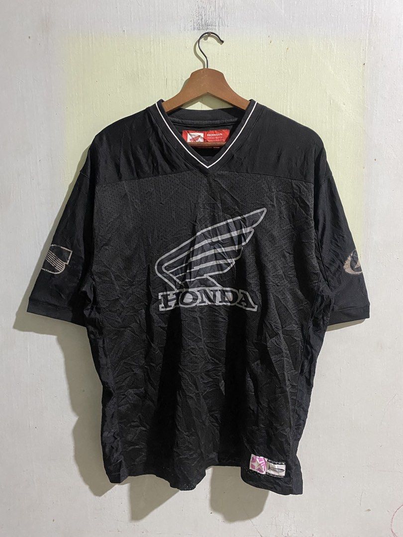 Honda Phys Dept Black Mesh Jersey (Category: Activewear) located in Pandi. Submitted by nasya_thrift_collection2023 (Listing ID 1469716892, Image 1). Description: - Brand: Honda Phys Dept - Item: Black Mesh Jersey - Size: Medium - Color: Black with white/silver graphics - Features: Breathable mesh fabric, V-neck collar, iconic Honda wing logo on chest and sleeves - Condition: 9/10, pre-loved and well-maintained - Style: Ideal for casual streetwea