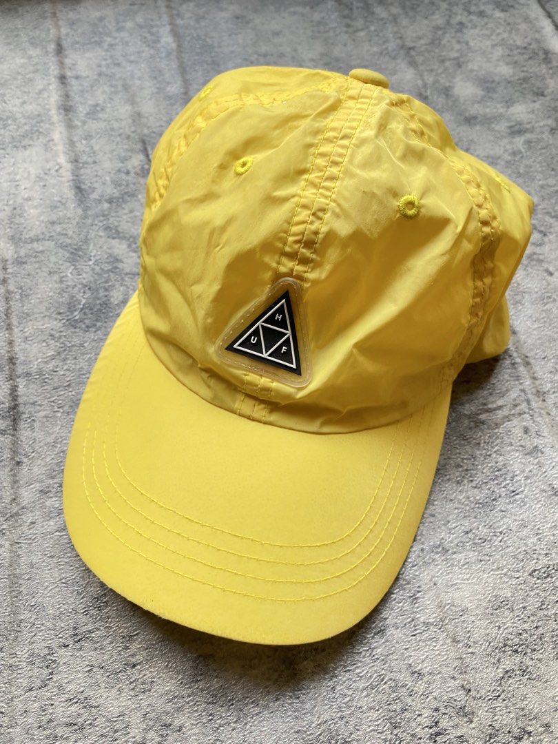 HUF Aurora Dad Hat (Category: Caps & Hats) located in Manila. Submitted by kiddrevoo (Listing ID 1469711179, Image 1). Description: HUF Aurora Dad Hat “Blazing Yellow” This unstructured 6-panel strapback cap is constructed from a lightweight, quick-dry nylon fabric. It features an adjustable strap, top ventilation eyelets, and a curved visor. The front is styled with a distinct raised rubber or silicone translucent triangular patch enclosing the 