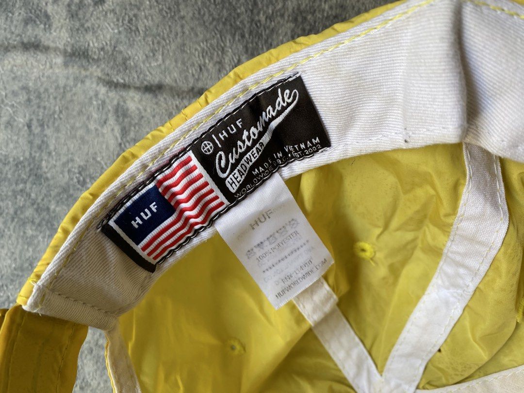 HUF Aurora Dad Hat (Category: Caps & Hats) located in Manila. Submitted by kiddrevoo (Listing ID 1469711179, Image 3). Description: HUF Aurora Dad Hat “Blazing Yellow” This unstructured 6-panel strapback cap is constructed from a lightweight, quick-dry nylon fabric. It features an adjustable strap, top ventilation eyelets, and a curved visor. The front is styled with a distinct raised rubber or silicone translucent triangular patch enclosing the 