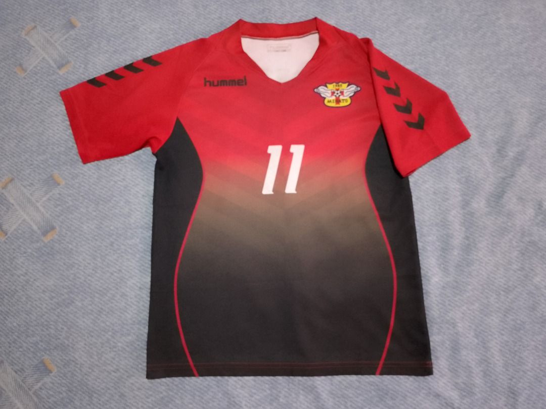 Hummel Soccer Jersey Red Black (Category: Babies & Kids Fashion) located in Bayombong. Submitted by daily10 (Listing ID 1469627840, Image 2). Description: - Brand: Hummel - Est Size: 150 - Dimensions: 17" x 23" inches - Club: Minato 1985 - Design: Red and black gradient with number 11 on the front - Details: Hummel logo on right chest, iconic chevrons on both sleeves - Neckline: V-neck collar - Material: Lightweight and breathable fabric -All Ite