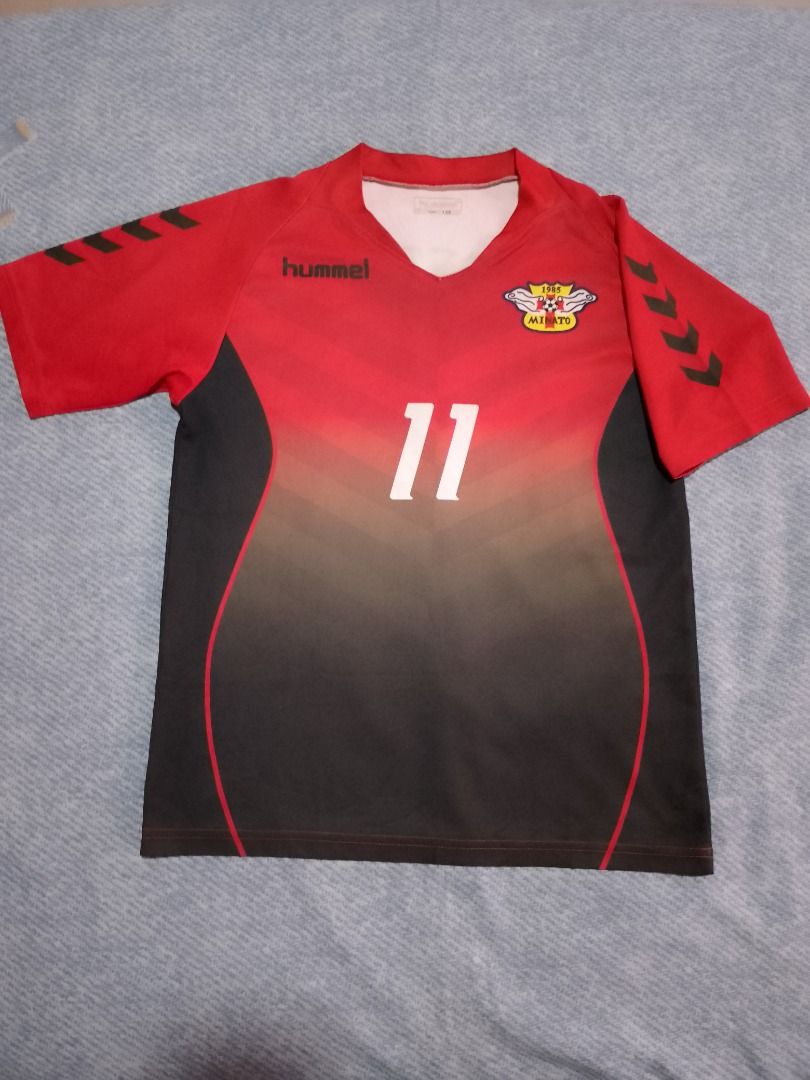 Hummel Soccer Jersey Red Black (Category: Babies & Kids Fashion) located in Bayombong. Submitted by daily10 (Listing ID 1469627840, Image 1). Description: - Brand: Hummel - Est Size: 150 - Dimensions: 17" x 23" inches - Club: Minato 1985 - Design: Red and black gradient with number 11 on the front - Details: Hummel logo on right chest, iconic chevrons on both sleeves - Neckline: V-neck collar - Material: Lightweight and breathable fabric -All Ite