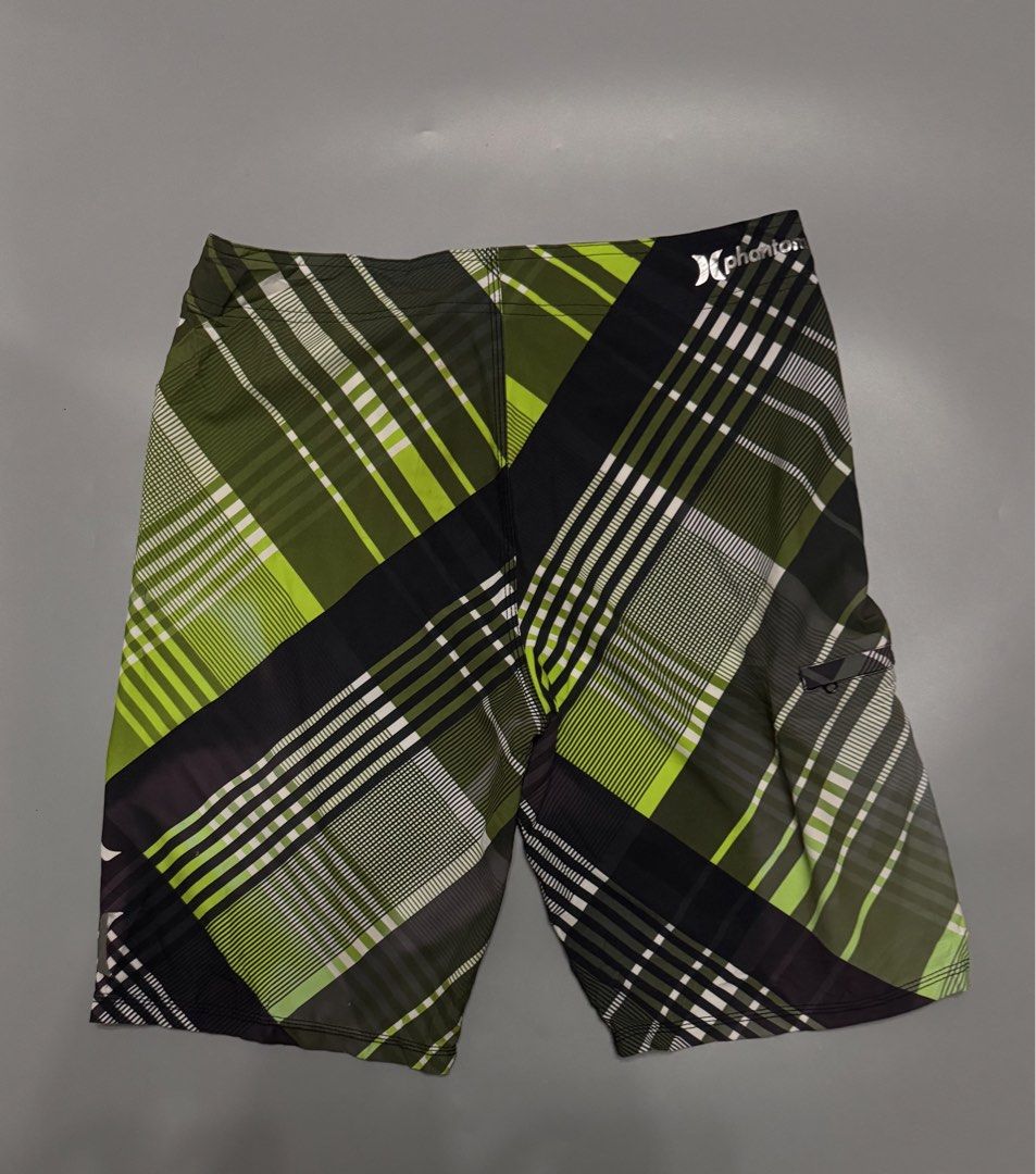 Hurley Phantom Green Plaid Board Shorts (Category: Swim Trunks & Board Shorts) located in Alaminos. Submitted by outfitcheck.ph (Listing ID 1469698866, Image 3). Description: - Brand: Hurley Phantom - Design: Green, black, and white plaid - Waistband: Drawstring with Hurley logo lettering - Pockets: Convenient small zip pocket on the right leg - Branding: Iconic Hurley logos on the left leg and back waist - Condition: Excellent / Great for surf, 