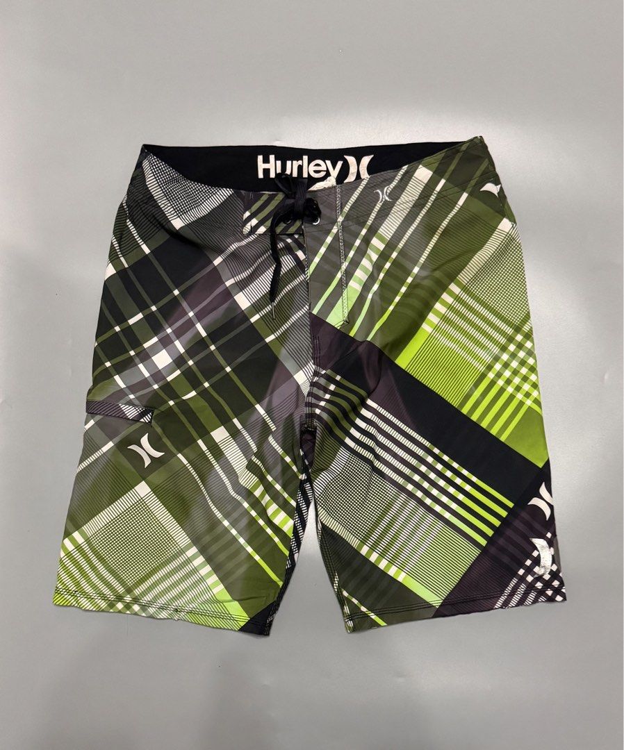 Hurley Phantom Green Plaid Board Shorts (Category: Swim Trunks & Board Shorts) located in Alaminos. Submitted by outfitcheck.ph (Listing ID 1469698866, Image 1). Description: - Brand: Hurley Phantom - Design: Green, black, and white plaid - Waistband: Drawstring with Hurley logo lettering - Pockets: Convenient small zip pocket on the right leg - Branding: Iconic Hurley logos on the left leg and back waist - Condition: Excellent / Great for surf, 