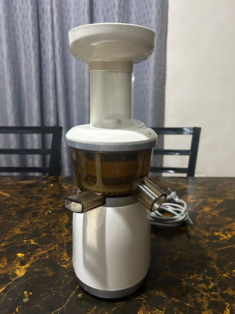 Hurom Electric Juicer slow (Category: Juicers, Blenders & Grinders) located in Taguig. Submitted by lhadychinitah (Listing ID 1469681399, Image 1). Description: - Brand: Hurom - Type: Electric Slow Juicer - Color: White with translucent brown chamber - Condition: Good, well-maintained, comes disassembled for easy cleaning - Features: On/Rev switch, sturdy base, efficient slow-juicing mechanism.