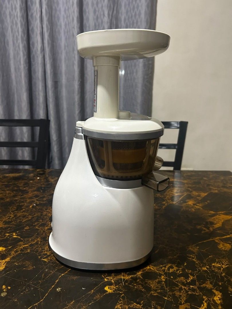 Hurom Electric Juicer slow (Category: Juicers, Blenders & Grinders) located in Taguig. Submitted by lhadychinitah (Listing ID 1469681399, Image 2). Description: - Brand: Hurom - Type: Electric Slow Juicer - Color: White with translucent brown chamber - Condition: Good, well-maintained, comes disassembled for easy cleaning - Features: On/Rev switch, sturdy base, efficient slow-juicing mechanism.