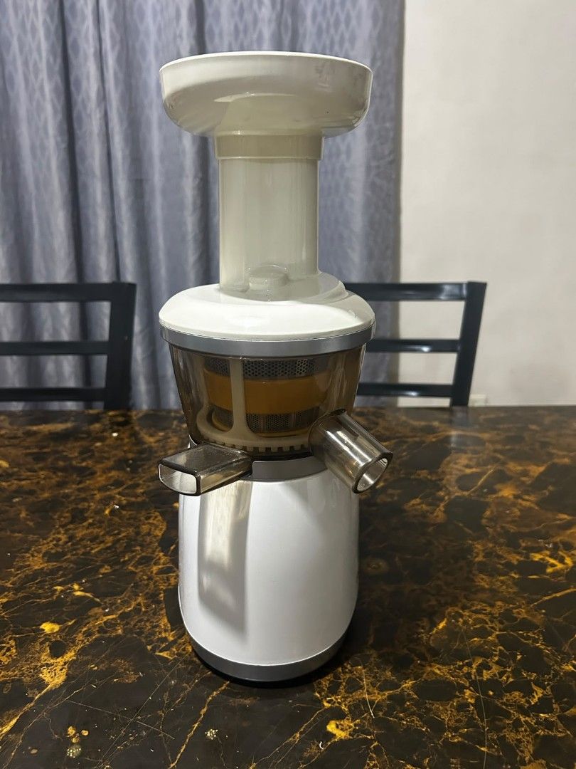 Hurom Slow Juicer (Category: Juicers, Blenders & Grinders) located in Taguig. Submitted by lhadychinitah (Listing ID 1469682110, Image 2). Description: - Brand: Hurom Slow Juicer - Color: White with clear/yellow strainer components - Condition: Good pre-loved condition, complete parts included (motor base, juicing bowl, auger, strainer, hopper, pusher) - Features: Slow squeezing technology for maximum nutrient retention, easy-to-use ON/REV switch