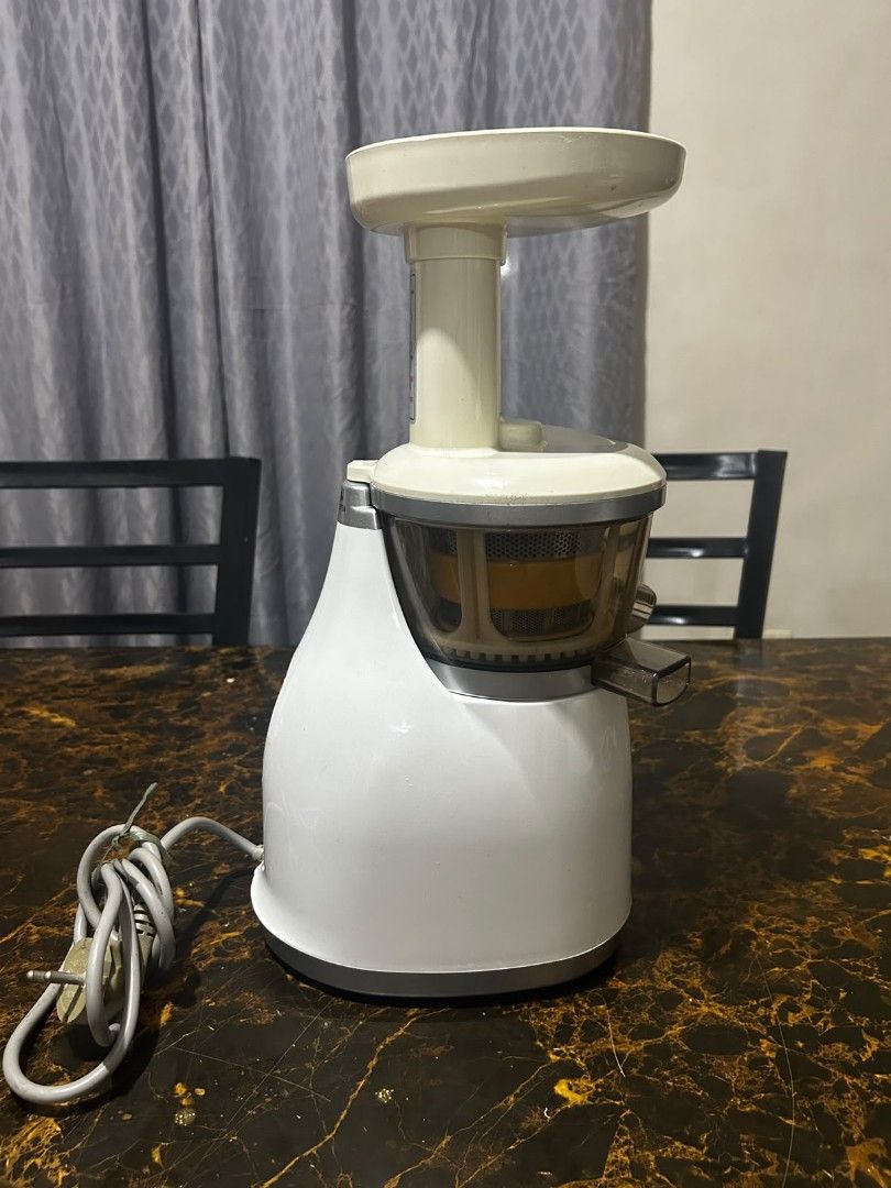 Hurom Slow Juicer (Category: Juicers, Blenders & Grinders) located in Taguig. Submitted by lhadychinitah (Listing ID 1469682110, Image 3). Description: - Brand: Hurom Slow Juicer - Color: White with clear/yellow strainer components - Condition: Good pre-loved condition, complete parts included (motor base, juicing bowl, auger, strainer, hopper, pusher) - Features: Slow squeezing technology for maximum nutrient retention, easy-to-use ON/REV switch