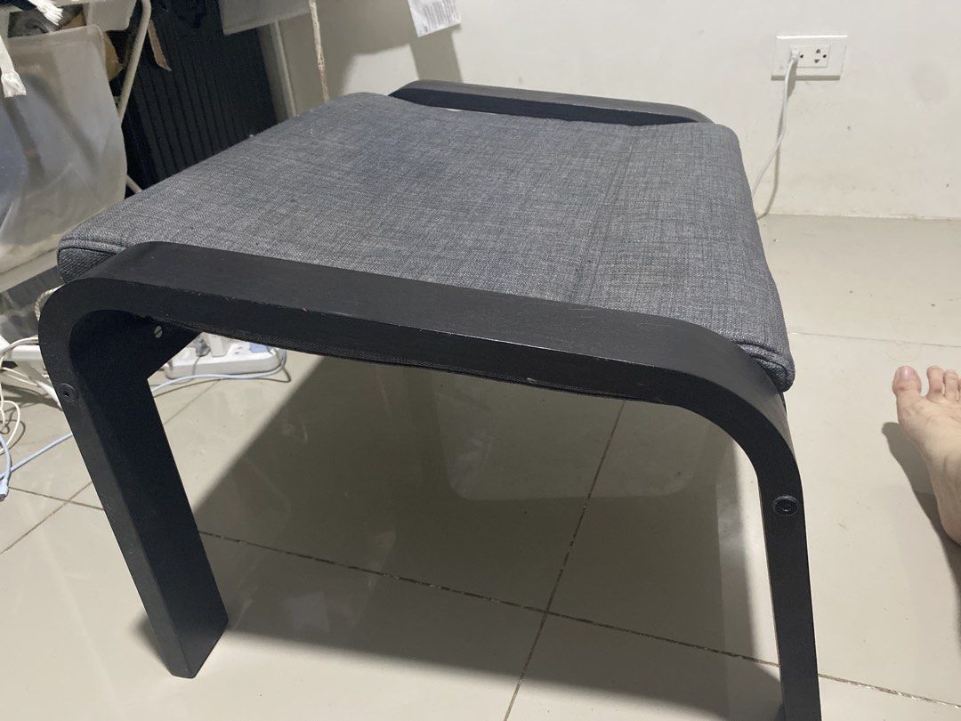 IKEA Poang Footstool Grey Black (Category: Chairs) located in Makati City. Submitted by arthadecluttering (Listing ID 1469675935, Image 1). Description: IKEA Poang footstool with a dark brown wood frame and grey cushion. Super comfortable and in clean condition with the fabric tag still attached. Di ginagamit nakatambak lang. No issue. Slight negotiable if kunin agad..