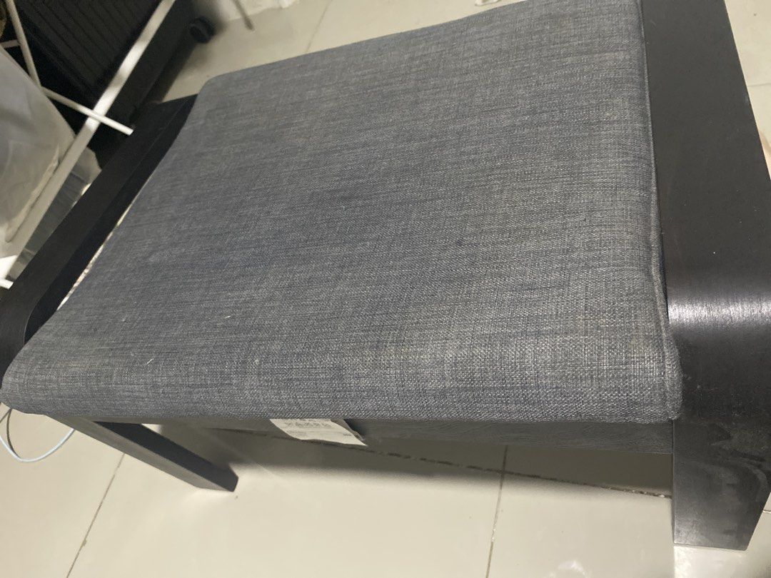 IKEA Poang Footstool Grey Black (Category: Chairs) located in Makati City. Submitted by arthadecluttering (Listing ID 1469675935, Image 2). Description: IKEA Poang footstool with a dark brown wood frame and grey cushion. Super comfortable and in clean condition with the fabric tag still attached. Di ginagamit nakatambak lang. No issue. Slight negotiable if kunin agad..