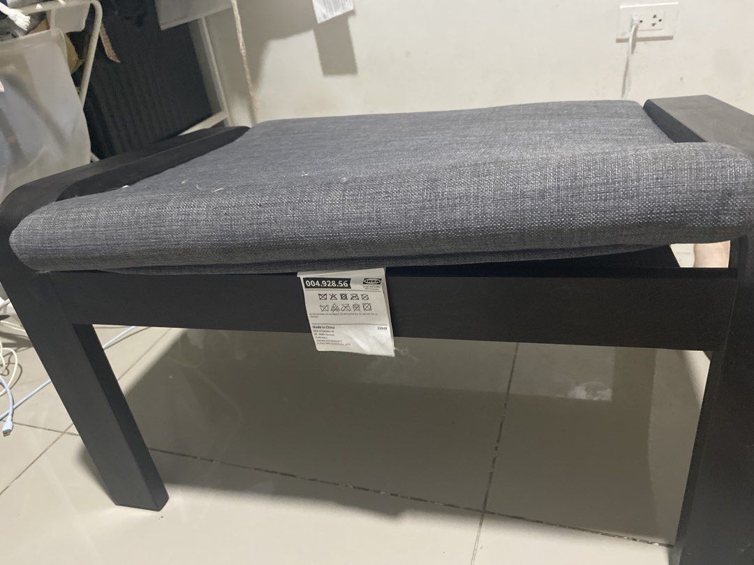 IKEA Poang Footstool Grey Black (Category: Chairs) located in Makati City. Submitted by arthadecluttering (Listing ID 1469675935, Image 3). Description: IKEA Poang footstool with a dark brown wood frame and grey cushion. Super comfortable and in clean condition with the fabric tag still attached. Di ginagamit nakatambak lang. No issue. Slight negotiable if kunin agad..