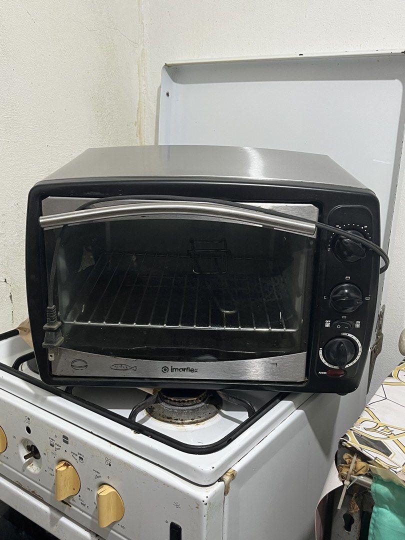 Imarflex Toaster Oven Black Stainless Steel (Category: Ovens & Toasters) located in Paranaque City. Submitted by mavicoslop (Listing ID 1469642442, Image 2). Description: - Brand: Imarflex - Finish: Sleek black and stainless steel - Controls: Convenient right-side rotary dials for temperature, cooking mode, and power timer - Design: Pull-down glass door for easy viewing and access - Inclusions: Comes with a wire rack and baking tray - Condition: 