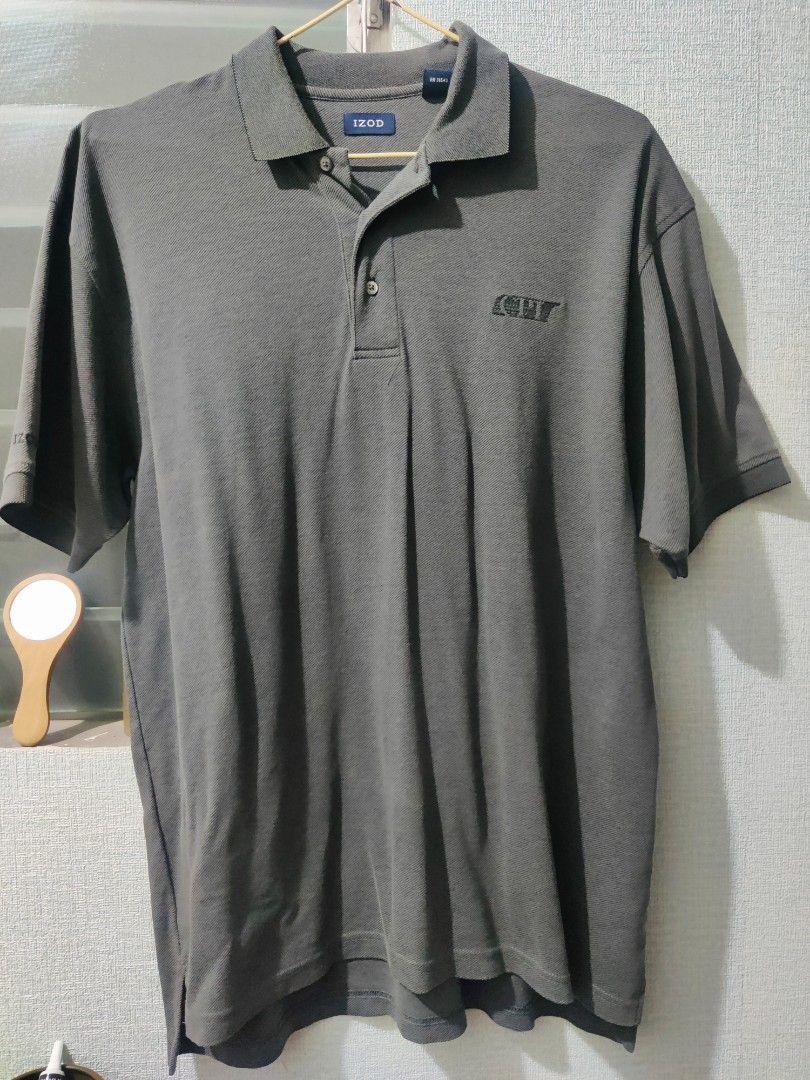IZOD Polo Shirt (Category: Tshirts & Polo Shirts ) located in Pasig City. Submitted by shiyenaaa (Listing ID 1469670265, Image 1). Description: - Brand: IZOD - Color: Grey - Material: Comfortable cotton blend with textured diagonal knit - Fit: Standard fit - Details: Classic collar, two-button placket, embroidered chest logo, and branding on the right sleeve cuff - Condition: Excellent - Style: Versatile for casual outings or smart-casual days.