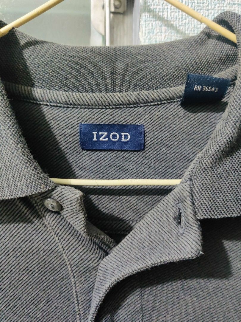 IZOD Polo Shirt (Category: Tshirts & Polo Shirts ) located in Pasig City. Submitted by shiyenaaa (Listing ID 1469670265, Image 3). Description: - Brand: IZOD - Color: Grey - Material: Comfortable cotton blend with textured diagonal knit - Fit: Standard fit - Details: Classic collar, two-button placket, embroidered chest logo, and branding on the right sleeve cuff - Condition: Excellent - Style: Versatile for casual outings or smart-casual days.