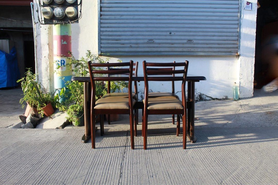 Japan 4-Seater Solid Wood Dining Set 🇯🇵 (Category: Tables & Sets) located in San Fernando. Submitted by juls.japan.surplus (Listing ID 1469715029, Image 2). Description: 4-Seater Solid Wood Dining Set Dark brown tabletop, sturdy dual-pedestal base and four matching wooden chairs with curved backrests and padded leather seats. Perfect for elegant dining areas Table size L:53 ¼ • W:31 ½ • H:27 ½ Chairs size L:16 ½ • W:17 ¾ • Seat H:17 ¾ • Back H: