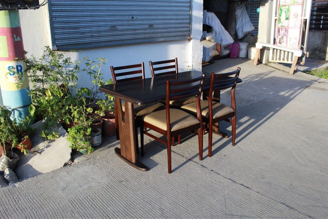 Japan 4-Seater Solid Wood Dining Set 🇯🇵 (Category: Tables & Sets) located in San Fernando. Submitted by juls.japan.surplus (Listing ID 1469715029, Image 3). Description: 4-Seater Solid Wood Dining Set Dark brown tabletop, sturdy dual-pedestal base and four matching wooden chairs with curved backrests and padded leather seats. Perfect for elegant dining areas Table size L:53 ¼ • W:31 ½ • H:27 ½ Chairs size L:16 ½ • W:17 ¾ • Seat H:17 ¾ • Back H: