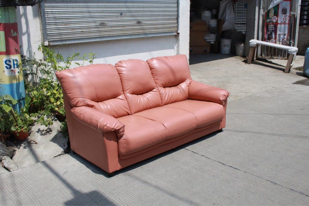 Japan Plush 3-Seater Leather Sofa 🇯🇵 (Category: Sofas) located in San Fernando. Submitted by juls.japan.surplus (Listing ID 1469715950, Image 3). Description: Plush 3-Seater Leather Sofa Comfortable 3-seater sofa with plush cushioning, segmented backrests and thick padded armrests. Upholstered in salmon pink textured leather, perfect for living rooms or relaxation areas L:66 • W:35 • Seat H:15 • Back H:33 • inches 13,300 pesos only.
