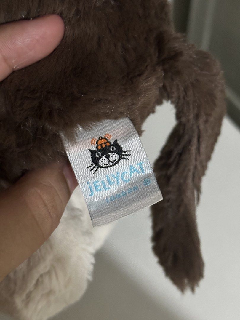 Jellycat Fudge Puppy Medium (Rare) (Category: Plushies & Soft Toys) located in Cabanatuan. Submitted by tinytreasuretales (Listing ID 1469604082, Image 2). Description: - Authentic Jellycat London puppy plush - Color: Brown and white - Super soft textured fur with floppy ears and sweet embroidered nose - Official stitched brand label attached at the back - Smoke-free and pet-free home - Perfect for gifts or collectors.