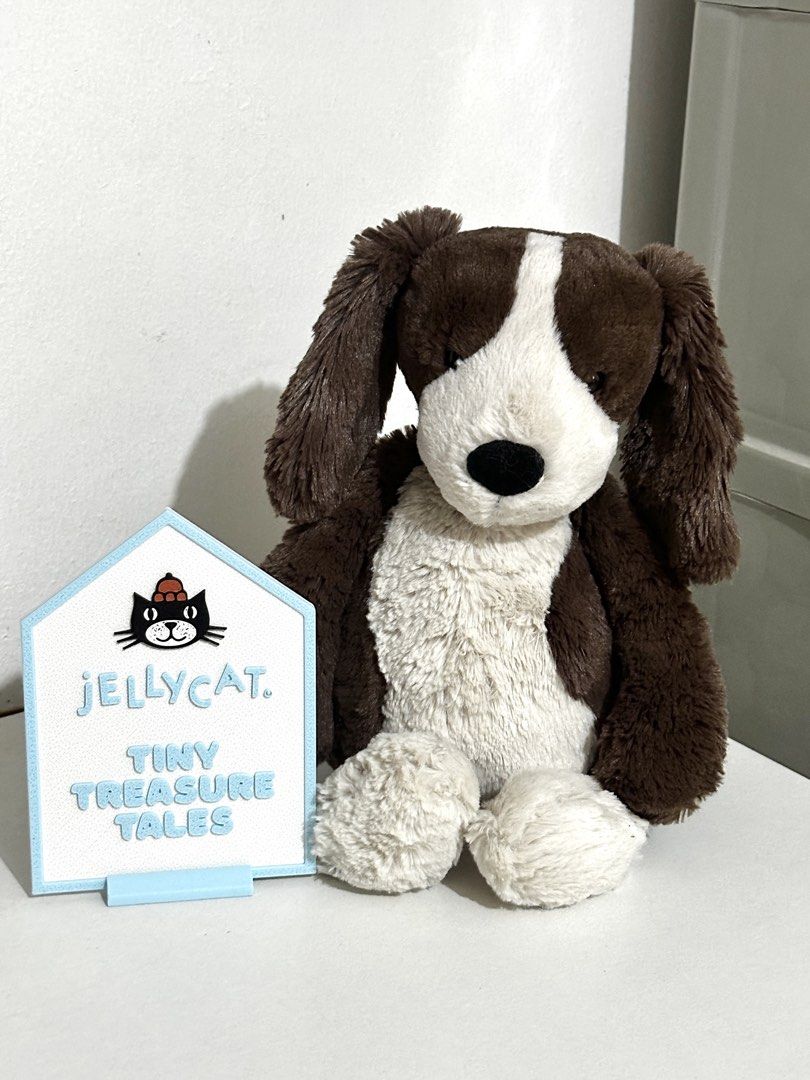 Jellycat Fudge Puppy Medium (Rare) (Category: Plushies & Soft Toys) located in Cabanatuan. Submitted by tinytreasuretales (Listing ID 1469604082, Image 1). Description: - Authentic Jellycat London puppy plush - Color: Brown and white - Super soft textured fur with floppy ears and sweet embroidered nose - Official stitched brand label attached at the back - Smoke-free and pet-free home - Perfect for gifts or collectors.