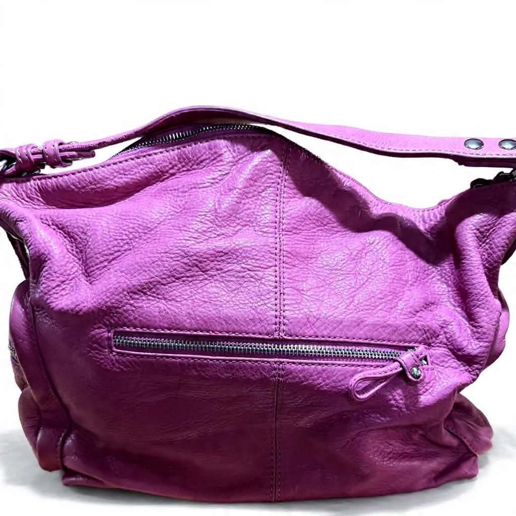 Jill Scott's Pink Leather Hobo Bag (Category: Luxury Bags & Wallets) located in Cavite. Submitted by bags_unltd143 (Listing ID 1436292580, Image 2). Description: Jill Scott hobo bag is crafted from pink leather. It features a top handle, a main compartment with a zipper closure, and exterior pockets. The bag has a silver-tone logo tag and silver hardware..