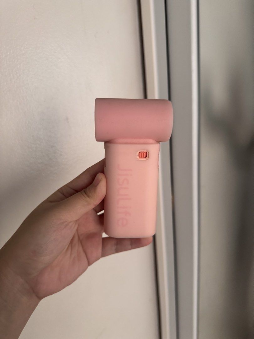 Jisulife Handheld Fan Pink (Category: Fans) located in Villasis. Submitted by thriftbyashi (Listing ID 1469638674, Image 1). Description: - No charger UNIT ONLY - Authentic Jisulife portable mini fan in a cute pink shade - Condition: Working great, well-maintained - Type-C rechargeable for easy and fast charging on the go - Compact and lightweight design, perfect for daily commute or travel - Adjustable speed settings with a handy power button ri