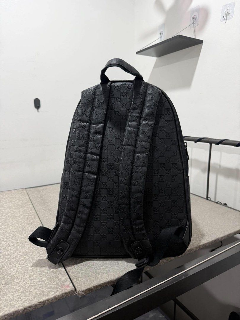 Jordan Black Monogram Backpack (Category: Backpacks) located in Manila. Submitted by dralphv (Listing ID 1469707919, Image 2). Description: - Authentic Black Jordan backpack with embossed '23' monogram pattern - Features a sleek bronze Jumpman logo on the front pocket - Main zippered compartment plus a handy front zip pocket - Padded shoulder straps and top carry handle for maximum comfort - Clean structure with smooth, durable zippers - Conditio