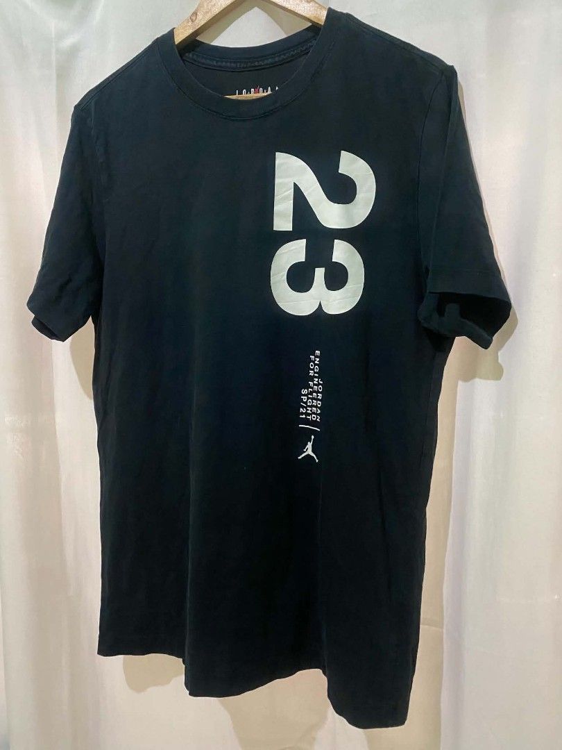 Jordan Engineered For Flight 23 T-Shirt Black (Category: Tshirts & Polo Shirts ) located in Quezon City. Submitted by elihur.tuazon (Listing ID 1469681865, Image 1). Description: - Authentic Jordan brand t-shirt - Color: Black with bold white graphics - Design: Large number 23 front and back, Jumpman chest logo, and 'Engineered For Flight SP/21' text - Back Graphic: Michael Jordan wireframe dunking in front of a yellow globe - Fit: Regular fit, c